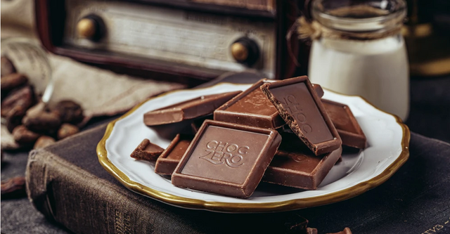 ChocZero squares on a white plate with a glass of milk
